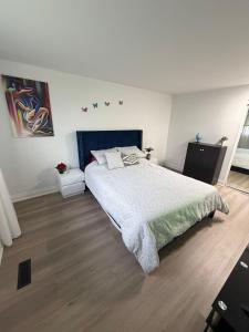 a bedroom with a large bed and wooden floors at Luxury Fun Villa in Toronto