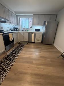 a kitchen with white cabinets and stainless steel appliances at Luxury Fun Villa in Toronto