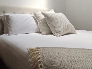 a white bed with four pillows and a blanket at Tamara Cottage Historic Warmth in Hobart +35 photos