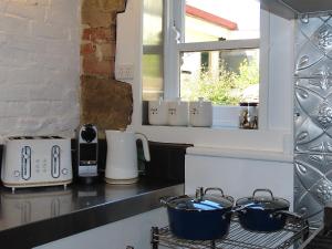 a kitchen counter with two pots on a stove at Tamara Cottage Historic Warmth in Hobart