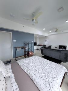 a bedroom with a large bed and a tub at Ezae Studio D'Perdana Apartment in Kota Bharu +8 photos
