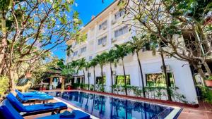 an image of a hotel with a swimming pool and trees at Harmony Hotel in Siem Reap