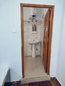 a bathroom with a toilet and a sink at Hotel vijaya in Phata