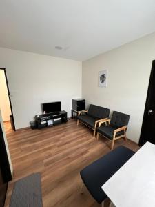 a living room with two chairs and a couch at JEC Suites in Kuching