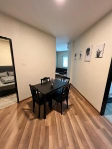 a dining room with a table and two chairs at JEC Suites in Kuching