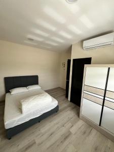 a bedroom with a bed and a sliding glass door at JEC Suites in Kuching