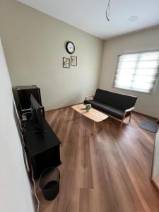 a living room with a couch and a table at JEC Suites in Kuching
