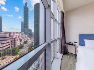 a hotel room with a view of a city at CHECK inn Taipei Xinyi in Taipei