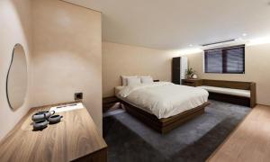 a bedroom with a bed and a mirror at Jamsil Orosie Hotel in Seoul +77 photos