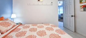 a bedroom with a bed with a blanket on it at Sand Star in Russel Island
