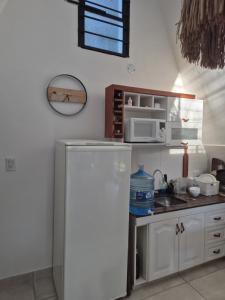 a kitchen with a white refrigerator and a sink at Estrellita Mia in Villa Ciudad Parque
