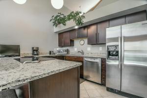 a kitchen with wooden cabinets and stainless steel appliances at Keystone Bristlecone Home 31 by SummitCove Lodging in Colorado in Keystone +38 photos