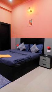 a bedroom with a bed with blue sheets and pillows at Quiet Corner 4BHK Villa in Lucknow +8 photos