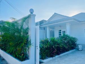 a white house with plants in front of it at Samui Serenity 63 Pool Villa in Choeng Mon Beach +46 photos