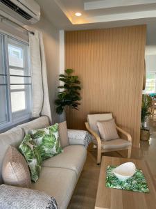 a living room with a couch and a table at Samui Serenity 63 Pool Villa in Choeng Mon Beach