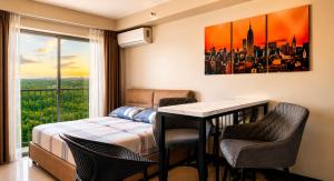 a bedroom with a bed and a table and chairs at Arastar Escape - Relax and Unwind- NetFlix - Fast Wifi - Pool Access in Suba +14 photos
