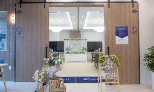 a conference room with a large door with a table and chairs at Archieve 4H hotel Busan in Busan