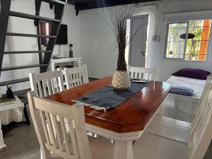 a dining room table with chairs and a vase on it at La Alpina playa Nebel in Concordia