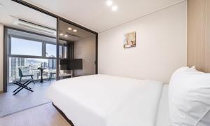 a bedroom with a white bed and a large window at Archieve 4H hotel Busan in Busan +22 photos