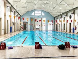 a large swimming pool in a large building at Altitude Suites on Yonge - Downtown Toronto Short Walk to SickKids, TMU & Eaton Centre in Toronto