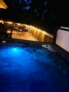 a hot tub in a yard at night with a deck at North Star Retreats in Beattyville