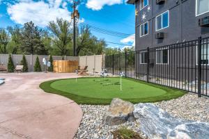 a miniature golf course in a yard next to a building at The Outrider Hotel in Manitou Springs