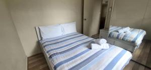 a bedroom with a bed with two towels on it at Little Sanctuary by Book Jervis Bay - Your Perfect Getaway, A Short Stroll to Palm Beach in Sanctuary Point