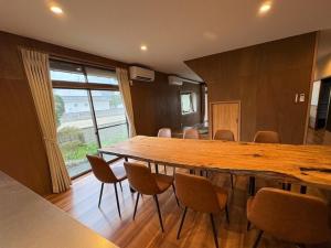 a conference room with a large wooden table and chairs at Yoike Stay in Yonago