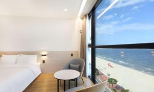 a hotel room with a bed and a view of the ocean at Pohang Hound Hotel Songdo Beach in Pohang +90 photos