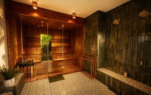 a large bathroom with a shower and a tub at Loku Kedungu - Boutique Resort in Tanah Lot