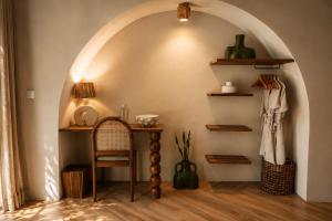 a room with an archway with a table and a chair at Loku Kedungu - Boutique Resort in Tanah Lot +4 photos
