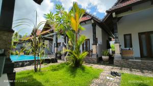 a villa with a pool and a house at Miko Bungalow Nusa Penida in Nusa Penida