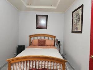 a bedroom with a wooden bed in a room at Mathildah's Appartements in Libreville
