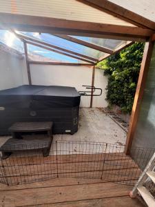 an outdoor patio with a grill and a large printer at L instant dore spa privatif in Cavaillon