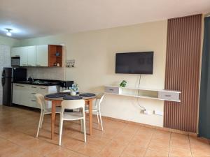 a kitchen and dining room with a table and chairs at Nice View always available in Juan Dolio +8 photos