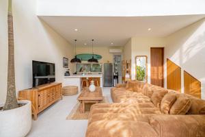 a living room with a couch and a tv at Villa Pia Pererenan in Cemagi +23 photos