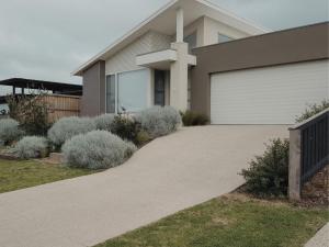 a driveway in front of a house with a cross at Adagio at Lonsdale in Point Lonsdale