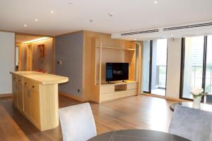 a living room with a tv and a table and chairs at The Quart Ruamrudee by UHG in Bangkok +136 photos