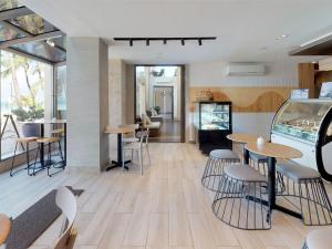 a restaurant with wooden floors and tables and chairs at The District Boracay in Boracay