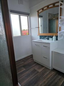 a bathroom with a sink and a mirror at The Crab Shack in Boonooroo +27 photos