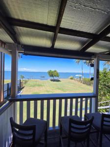 a porch with chairs and a view of the ocean at The Crab Shack in Boonooroo
