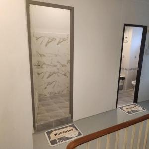a mirror on top of a counter in a bathroom at The Layover Donmueang Airport Hostel in Thung Si Kan
