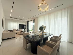 a living room with a glass table and chairs at Xanadu International Resort in Koh Rong Sanloem