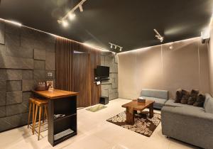 a living room with a couch and a table at Ohana Suites Yogyakarta in Yogyakarta