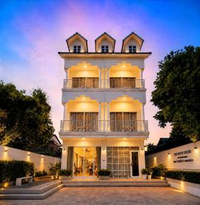 a large white building with a tower at The White House Rachamankha - Adults Only in Chiang Mai
