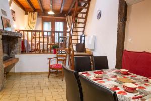 a dining room with a table and some chairs at La grange - 4/6 personnes in Saint-Pierre-de-Nogaret