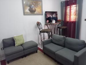 a living room with a couch and a table at Mathildah's Appartements in Libreville