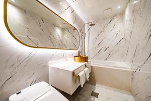a bathroom with a sink toilet and a mirror at Instar Hotel in Suwon +88 photos
