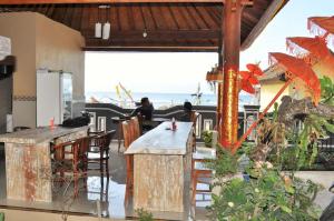 a bar with a view of the ocean at Deva Devi Beach Inn in Sampalan