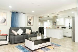 a living room with a couch and a table at Juliet's Cozy Retreat in Worcester